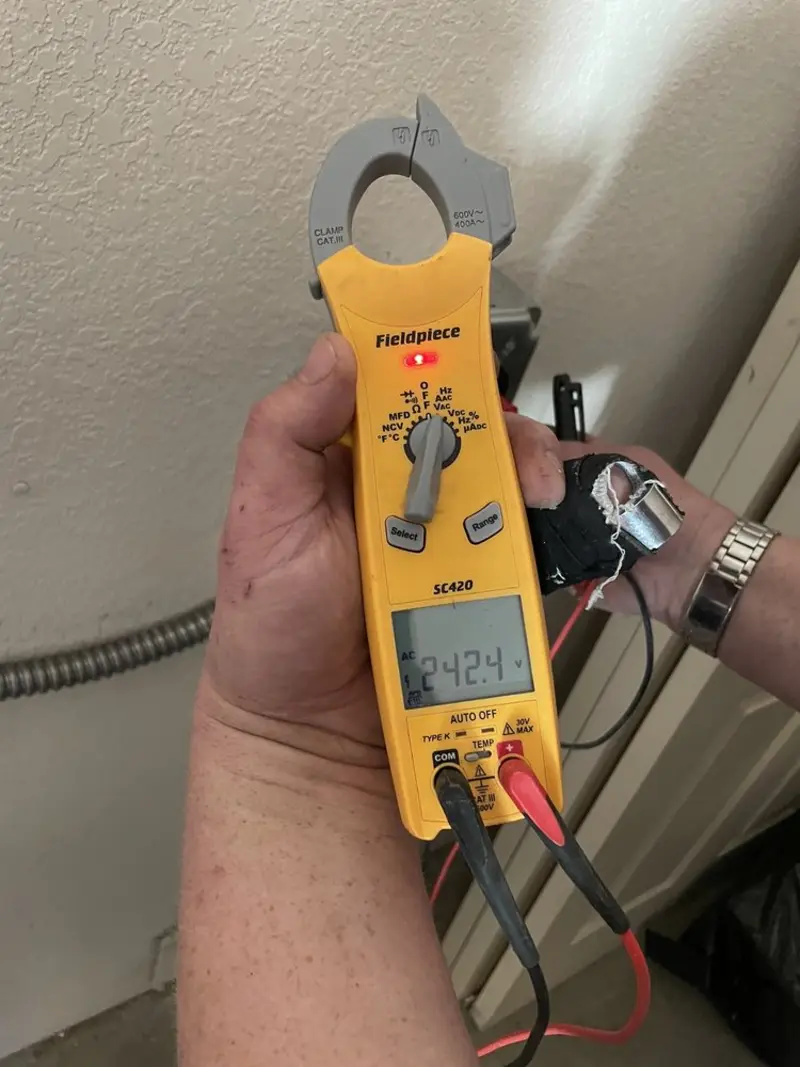 Voltage testing with clamp meter during Electrical Installation Services in Au Sable